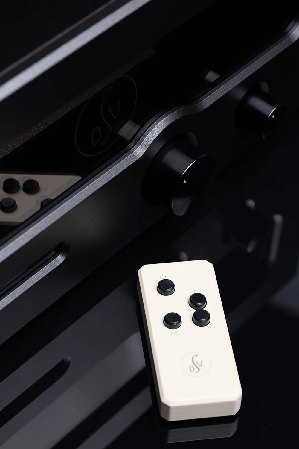The remote handset resting on the top cover of an OSV Audio amplifier