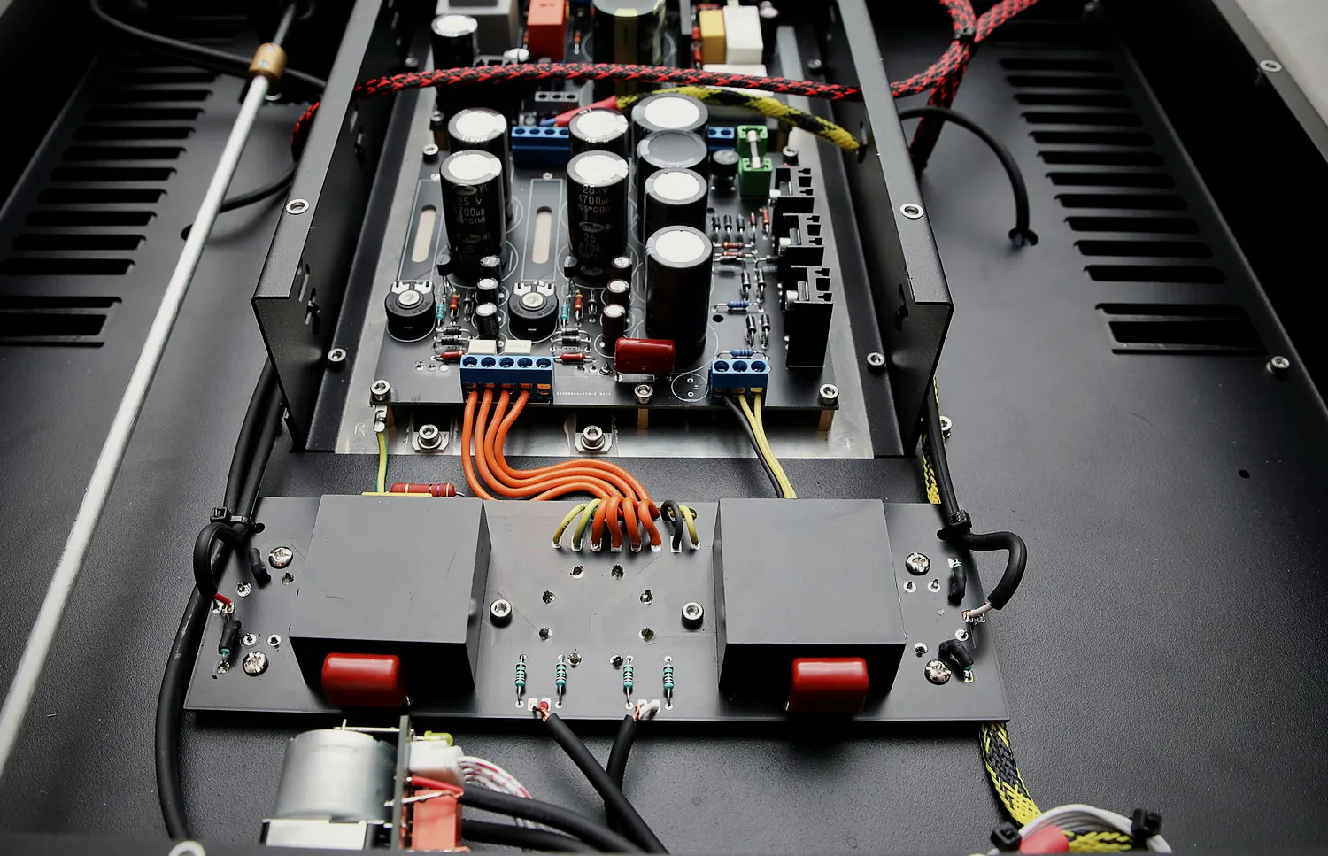An OSV Audio amplifier open on the bench: the regulator boards, the output stage and the hand dressed wiring